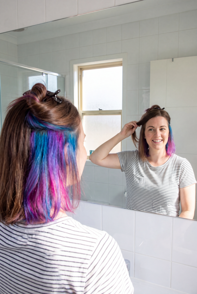 styling technique used to reveal hidden peekaboo hair color underneath